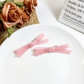 Detail of pink velvet bow hair clips on a white plate with elegant French style decor - Light Pink