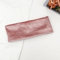 Detailed macro view of dusty pink velvet elastic headband on minimalist textured white background - Pink