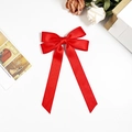 Elegant red satin bow hair clip with long ribbons on a white background with floral decor - Red