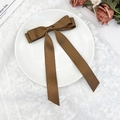 Detailed close-up of a brown satin double-layer bow hair clip with elegant long ribbons - Brown