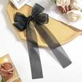 Detailed view of elegant black organza double-layered bow hair clip with long ribbons - Black