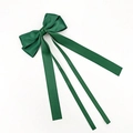 Detail of dark green satin bow hair clip with long ribbons and silky glossy finish - Christmas Green