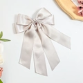 Detailed view of champagne satin bow hair clip with elegant long draping ribbons - Light Gray