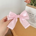 Detail of pink satin bow hair clip with high-density silk shine and layered structure - Pink