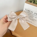 Detail of elegant champagne gold satin bow hair clip with a silky smooth fabric texture - Champagne Gold