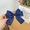 Detail of dark blue satin ribbon bow hair clip with a silky texture and layered design - Dark Blue