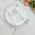 Macro detail of white satin double-layered bow hair clip with elegant long flowing ribbons - White
