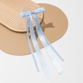 Detail of light blue gingham ribbon bow accessory on a textured glass cup - Blue