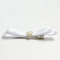 Detail of white bow hair clip with heart pearl accent on a metal duckbill clip - White