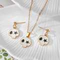 Close-up of alloy skull jewelry set with white enamel and star eyes on a shell tray - White Skull with Black Star (C)