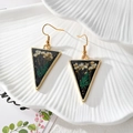 Detail view of triangular resin earrings with real dried flowers and gold foil accents - Triangular White Flower