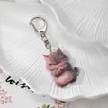 Macro detail of cute acrylic angry cat keychain with premium silver metal clasp hardware - Angry Cat