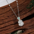 Detail of hulu gourd pendant with white stone inlay and green gem on dark wood - Double Gourd White Style (C)