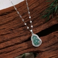 Elegant gourd-shaped green zircon pendant with silver chain on a dark wood background - Green Chalcedony Style (D)