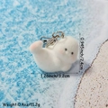 Cute white flocked seal keychain charm with metal ring on blue beach background - Side Lying Seal