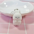 Close-up of white flocked bunny keychain with pink nose on a cute checkered tabletop - Congratulations Rabbit