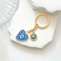 Macro view of golden evil eye keychain with blue heart drop oil and sparkling rhinestones - Enamel Heart Rhinestone Style / Blue Heart