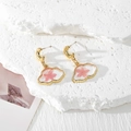 Close-up of cloud resin earrings with real pink dried flowers and gold moon hooks - Pink Flower Cloud