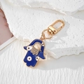 Detailed view of Hamsa Hand keychain with blue enamel, crystals, and gold plating - Dark Blue Hollow Hand