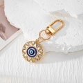 Llavero Ojo de la Suerte dorado con diseño de sol y cristaux brillantes - Ojo Hueco Puntiagudo Dorado