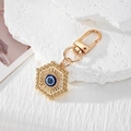 Portachiavi Mano di Fatima dorato con occhio turco blu su base in pietra bianca - Occhio Esagonale Oro