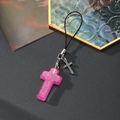 Pendentif croix en résine rose pailletée avec breloque strass sur une lanière noire - Croix Rouge Rose
