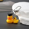 Cute resin graduation yellow duck keychain with mortarboard and sunglasses on grey background - Graduation Duck