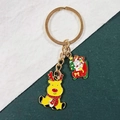 Detail of Christmas keychain with yellow reindeer and snowman on a red sleigh charm - Christmas Gift