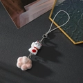 Detail of cute lucky cat keychain with pink flocking paw on a dark textured background - Brown Heart Cat Paw