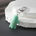 Detailed view of the cute flocked green turtle keychain with a silver metal lobster clasp - Lazy Turtle
