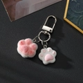 Cute pink plush and resin cat paw keychain with silver metal clasp on black background - Rose Red Heart Cat Paw
