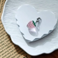 Macro detail of a pink resin strawberry charm with realistic texture and a silver lobster clasp - Pink Strawberry (Silver Clasp)
