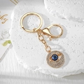Macro detail of Evil Eye keychain with golden finish and sparkling white rhinestones - Gold Hollow Round Eye (11)