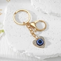 Detail of a golden heart keychain with Evil Eye enamel and sparkling rhinestones on stones - Gold Heart (10)