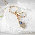 Golden Hamsa Hand keychain with blue evil eye and sparkling rhinestones on stone background - Medium Gold Hamsa Hand (9)