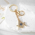 Close-up of Freemason compass and square keychain with blue evil eye and sparkling crystals - Masonic Gold Eye (8)