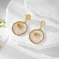 Handmade resin daisy flower earrings with gold frame and dried stones on stone background - One Yellow Daisy With Crushed Stone