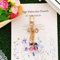 Detail of pink cherry keychain with gold metal clasp and green enamel leaves - Peach Pink Cherry