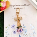 Close-up of cute purple cherry keychain with gold metal clasp and green leaves detail - Purple Cherry