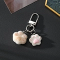 Cute beige fuzzy cat paw keychain with pink resin detail and silver metal clip - Yellow Heart Cat Paw