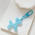 Close-up of light blue balloon dog keychain with iridescent pearlescent finish - Laser Light Blue