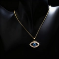 Gold Evil Eye necklace with blue stone and rhinestone pave on a black neck display - Medium Gold Hollow Slanted Eye