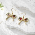 Detailed close-up of handmade gold bow earrings with real red dried flowers in resin - Stainless Steel Earring Hook / Red Flower Green Leaf Large Bow