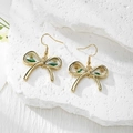 Detailed close-up of bow earrings with real white dried flowers and green leaves inlay - Stainless Steel Earring Hook / White Flower Green Leaf Large Bow