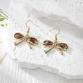 Detailed macro view of handmade bow earrings with real purple dried flowers in resin - Stainless Steel Earring Hook / Purple Flower White Gypsophila Small Bow