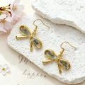Macro shot of gold bow earrings with blue dried flowers in clear resin on white stone - Stainless Steel Earring Hook / Blue Flower White Gypsophila Small Bow
