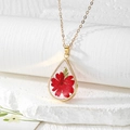 Detail view of water drop resin pendant with real red dried flowers and gold foil - Red Flower with Green Leaves (Gold Foil Style)
