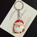 Grote Kerstman sleutelhanger voor tassen met rode hars bedeltjes en feestelijke details - Kerstman Hand Omhoog Stijl (B)