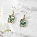 Detailed close-up of handmade gold earrings with green dried flowers and gold foil accents - Green Leaf Artificial Pearl (Stainless Steel Hook)