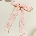 Detailed view of pink satin bow hair clip with ruffle edges and small white pearls - Orange Pink